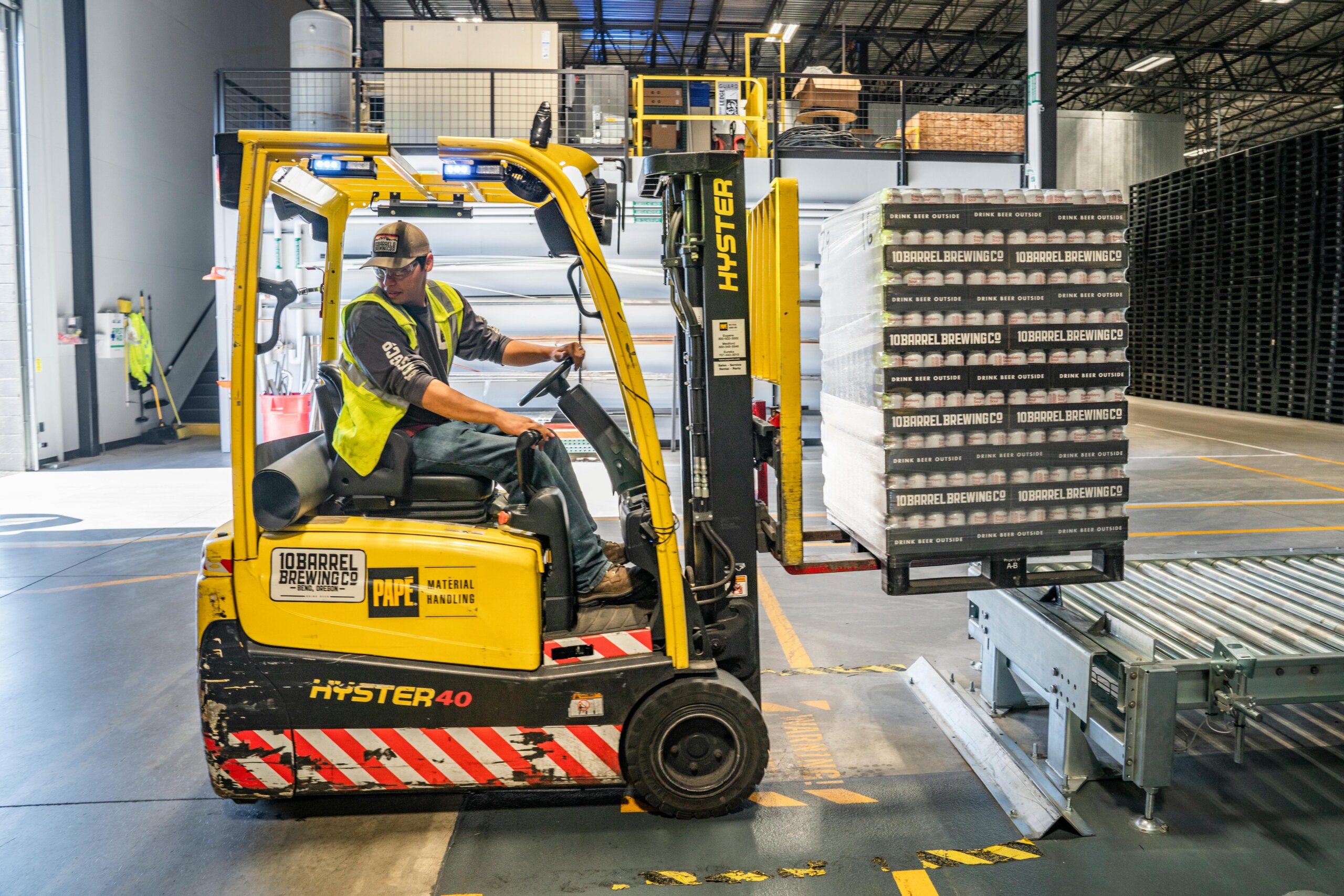 a person driving a forklift in a warehouse