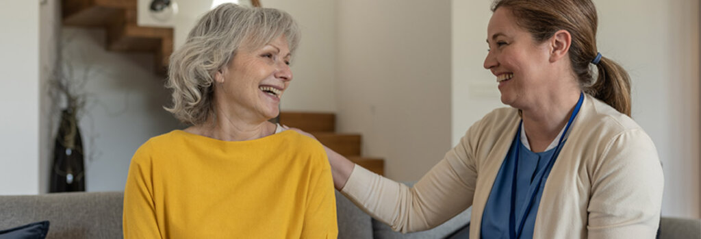 A nurse kindly assists a patient.